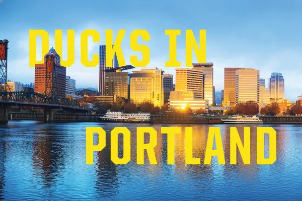 A cityscape with text that reads Ducks In Portland