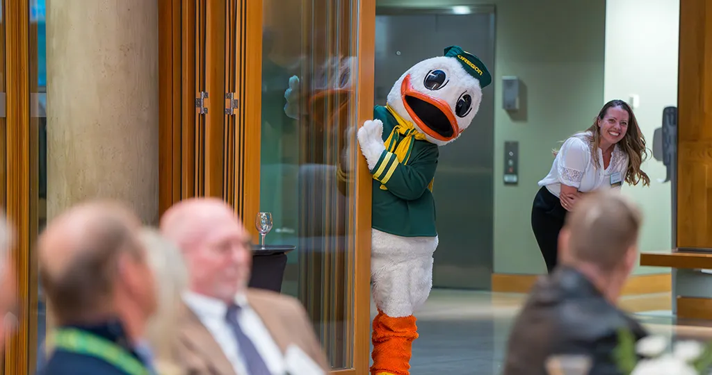 Oregon Duck peeks out from behind a door