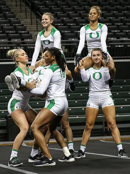 Calyx Hampton holds a teammate up as a base during a meet for Oregon Acrobatics and Tumbling.